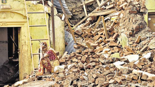 Anita Patil (45) looks at what is remaining of her house destroyed by floods in Prayag Chikhli village in Kolhapur on Saturday.(Pratham Gokhale/HT Photo)