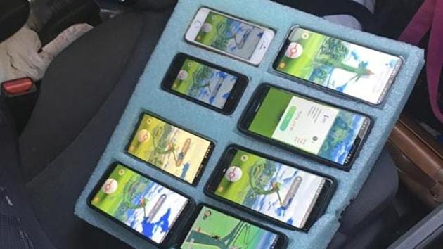A piece of foam, cut to hold eight mobile phones in place -- all of them playing the game Pokemon Go -- is shown on the passenger seat of a vehicle driven by a person who was found pulled over on the shoulder of a highway in Washington state near Seattle by a Washington state trooper who thought the driver needed assistance.(AP) A piece of foam, cut to hold eight mobile phones in place -- all of them playing the game Pokemon Go -- is shown on the passenger seat of a vehicle driven by a person who was found pulled over on the shoulder of a highway in Washington state near Seattle by a Washington state trooper who thought the driver needed assistance.(AP)