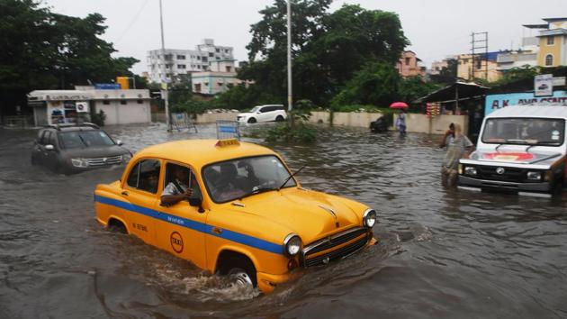 A taxi driver makes his way through a flooded street following heavy rains in Kolkata, West Bengal. (Dibyangshu Sarkar / AFP) A taxi driver makes his way through a flooded street following heavy rains in Kolkata, West Bengal. (Dibyangshu Sarkar / AFP)