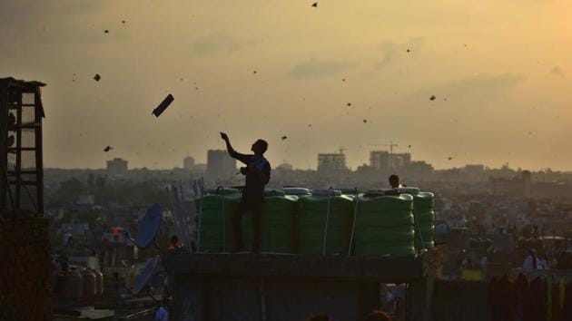 A man is silhouetted as people fly kites on the rooftop of their houses to celebrate India's 73rd Independence Day in the old quarters of the city, in New Delhi. (Raj K Raj / HT Photo) A man is silhouetted as people fly kites on the rooftop of their houses to celebrate India's 73rd Independence Day in the old quarters of the city, in New Delhi. (Raj K Raj / HT Photo)
