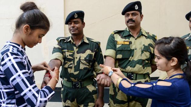 Women and girls tie 'rakhi' on the wrists of Border Security Force (BSF) personnel during a ceremony observing the festival of Rakshabandhan at the India-Pakistan Wagah border, about 35 km from Amritsar, Punjab. (Narinder Nanu / AFP) Women and girls tie 'rakhi' on the wrists of Border Security Force (BSF) personnel during a ceremony observing the festival of Rakshabandhan at the India-Pakistan Wagah border, about 35 km from Amritsar, Punjab. (Narinder Nanu / AFP)