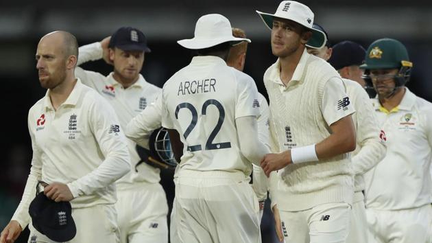 England's Jack Leach, left, England's Jofra Archer, and England's Stuart Broad shake hands.(AP)