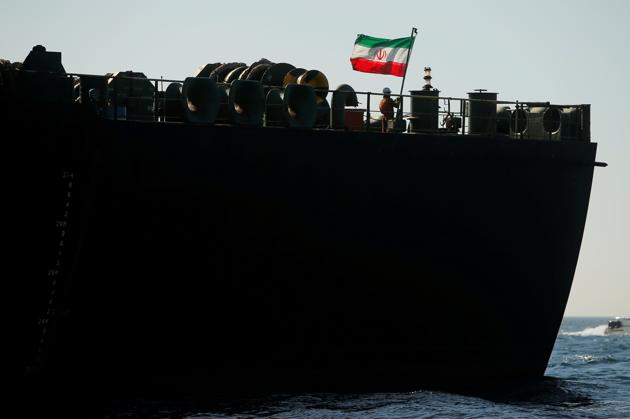 A crew member raises the Iranian flag on Iranian oil tanker Adrian Darya 1, previously named Grace 1, as it sits anchored after the Supreme Court of the British territory lifted its detention order, in the Strait of Gibraltar.(Reuters) A crew member raises the Iranian flag on Iranian oil tanker Adrian Darya 1, previously named Grace 1, as it sits anchored after the Supreme Court of the British territory lifted its detention order, in the Strait of Gibraltar.(Reuters)