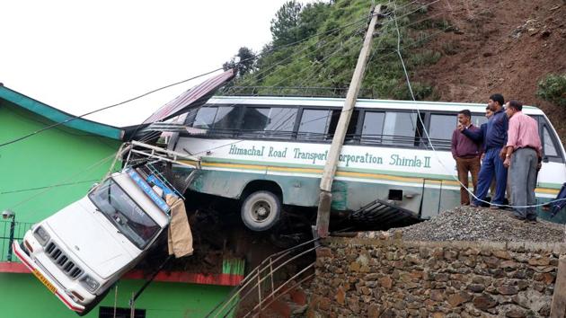 A parked HRTC bus and Bolero Camper were hit by debris after a massive landslide and pushed towards a road side building due to heavy rain near Mehli, in Shimla. As of Sunday evening, rain-related incidents had claimed at least 30 lives in Himachal Pradesh, four in Uttarakhand while dozens were reported injured. (Deepak Sansta / HT Photo) A parked HRTC bus and Bolero Camper were hit by debris after a massive landslide and pushed towards a road side building due to heavy rain near Mehli, in Shimla. As of Sunday evening, rain-related incidents had claimed at least 30 lives in Himachal Pradesh, four in Uttarakhand while dozens were reported injured. (Deepak Sansta / HT Photo)