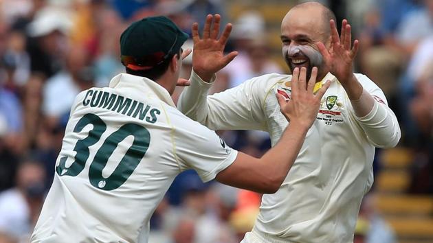 Australia's Nathan Lyon (R) celebrates with Australia's Pat Cummins (L) after taking the wicket of England's Ben Stokes.(AFP)