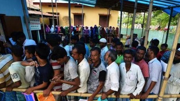 People wait in queue to check their names on the draft list at the National Register of Citizens (NRC) centre at a village in Assam. (Reuters Photo) People wait in queue to check their names on the draft list at the National Register of Citizens (NRC) centre at a village in Assam. (Reuters Photo)