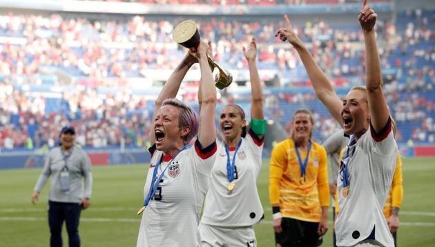 Megan Rapinoe of the U.S. celebrates with the trophy alongside Allie Long and Alex Morgan after winning the Women's World Cup.(REUTERS)
