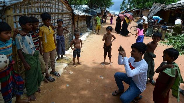 Rafiq is among some 30 Rohingya youths selected by the World Food Programme for its “Storytellers” project. For two weeks, they are taught smartphone photo and video-shooting techniques -- such as understanding light, exposure and angles -- as well as writing skills. The refugees then share their stories directly with the public through Facebook, Twitter and Instagram, with audiences around the world posting comments and asking questions. (Munir UZ ZAMAN / AFP) Rafiq is among some 30 Rohingya youths selected by the World Food Programme for its “Storytellers” project. For two weeks, they are taught smartphone photo and video-shooting techniques -- such as understanding light, exposure and angles -- as well as writing skills. The refugees then share their stories directly with the public through Facebook, Twitter and Instagram, with audiences around the world posting comments and asking questions. (Munir UZ ZAMAN / AFP)