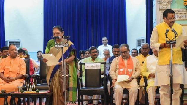 UP chief minister Yogi Adityanath looks on as governor Anandiben Patel administers oath to new minister Mahendra Singh at a ceremony at Raj Bhawan in Lucknow, Wednesday, Aug 21, 2019. (PTI) UP chief minister Yogi Adityanath looks on as governor Anandiben Patel administers oath to new minister Mahendra Singh at a ceremony at Raj Bhawan in Lucknow, Wednesday, Aug 21, 2019. (PTI)