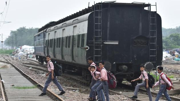 School children walk on railway tracks to reach school, at Prem Nagar, in New Delhi. (Sanchit Khanna/HT PHOTO) School children walk on railway tracks to reach school, at Prem Nagar, in New Delhi. (Sanchit Khanna/HT PHOTO)