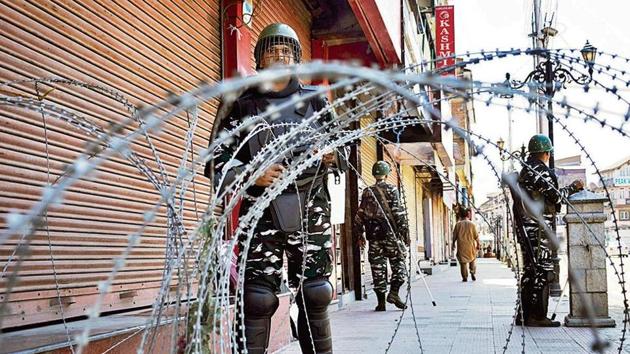 CRPF personnel stand guard in front of closed shops in Srinagar on Thursday. (ANI Photo) CRPF personnel stand guard in front of closed shops in Srinagar on Thursday. (ANI Photo)