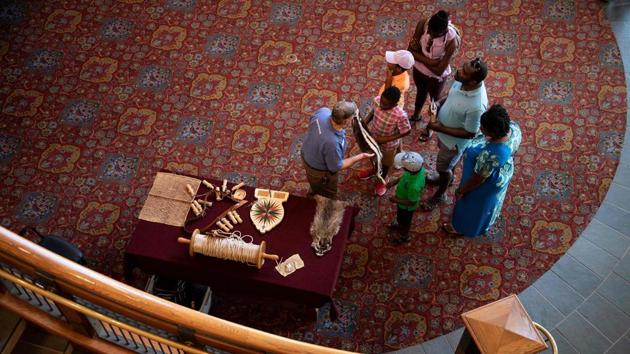Visitors look at reproduction of common 17th century items at the Jamestown Settlement. The only woman whose name was preserved for history was Angela, “the first documented African woman in Virginia,” said Bly Straube, the curator at the Jamestown Settlement, a living history museum. “To me, the story is sort of like Eve,” Straube said. (Brendan Smialowski / AFP) 