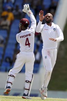 West Indies' bowler Roston Chase celebrates with teammate Shai Hope taking the wicket of India's KL Rahul. (AP) West Indies' bowler Roston Chase celebrates with teammate Shai Hope taking the wicket of India's KL Rahul. (AP)
