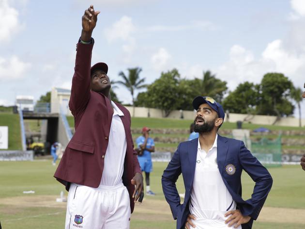 West Indies' captain Jason Holder flips the coin as India's captain Virat Kohli looks on. (AP) West Indies' captain Jason Holder flips the coin as India's captain Virat Kohli looks on. (AP)