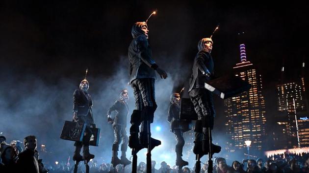 Performers on stilts from the Amsterdam street theatre troupe Close-Act entertain spectators during the White Night festival in Melbourne, Australia. (William West / AFP) Performers on stilts from the Amsterdam street theatre troupe Close-Act entertain spectators during the White Night festival in Melbourne, Australia. (William West / AFP)