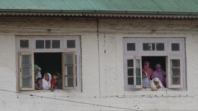 Women watch a protest march from the window of a mosque in Srinagar. Former Jammu and Kashmir chief ministers Mehbooba Mufti and Omar Abdullah, who were under house arrest since August 04, were arrested, hours after the revocation of Article 370. Jammu and Kashmir People’s Conference leaders Sajjad Lone and Imran Ansari were also arrested. (Dar Yasin / AP) Women watch a protest march from the window of a mosque in Srinagar. Former Jammu and Kashmir chief ministers Mehbooba Mufti and Omar Abdullah, who were under house arrest since August 04, were arrested, hours after the revocation of Article 370. Jammu and Kashmir People’s Conference leaders Sajjad Lone and Imran Ansari were also arrested. (Dar Yasin / AP)