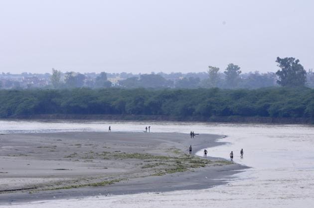 People out by the Yamuna after a recession in the water level of the river. Signboards or banners which display that throwing waste is not allowed shall be put up near lakes, warning of legal action in case of violation. (Photo by Sunil Ghosh / Hindustan Times) People out by the Yamuna after a recession in the water level of the river. Signboards or banners which display that throwing waste is not allowed shall be put up near lakes, warning of legal action in case of violation. (Photo by Sunil Ghosh / Hindustan Times)