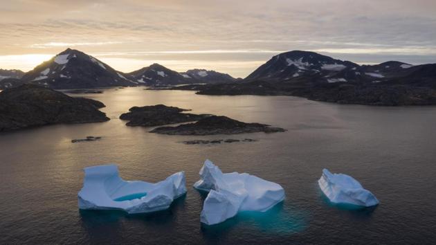 Large icebergs float away as the sun rises near Kulusuk, Greenland. Scientists are hard at work, trying to understand the alarmingly rapid melting of the ice. (Felipe Dana / AP) Large icebergs float away as the sun rises near Kulusuk, Greenland. Scientists are hard at work, trying to understand the alarmingly rapid melting of the ice. (Felipe Dana / AP)