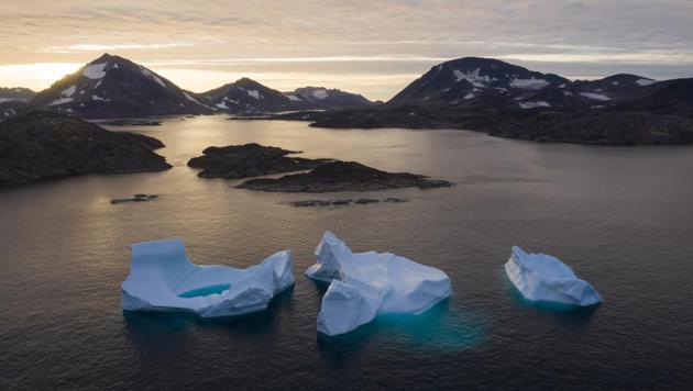 Large icebergs float away as the sun rises near Kulusuk, Greenland. Greenland's ice has been melting for more than 20 years, but in 2019, it's as if Earth's refrigerator door has been left open, and it means a potentially large rise in the world's sea levels. (Felipe Dana / AP) Large icebergs float away as the sun rises near Kulusuk, Greenland. Greenland's ice has been melting for more than 20 years, but in 2019, it's as if Earth's refrigerator door has been left open, and it means a potentially large rise in the world's sea levels. (Felipe Dana / AP)