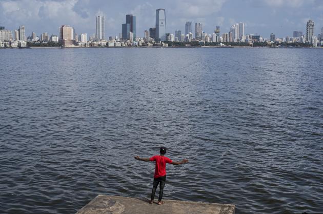 A boy poses for a picture in front of Mumbai skyline at Bandra in Mumbai, Maharashtra. (Satish Bate / HT Photo) A boy poses for a picture in front of Mumbai skyline at Bandra in Mumbai, Maharashtra. (Satish Bate / HT Photo)