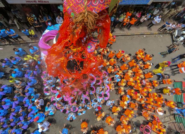 A Hindu devotee breaks a dahi-handi suspended in the air atop a human pyramid during celebrations for the Janmashtami festival, which marks the birth of Hindu God Lord Krishna, at Dadar in Mumbai, Maharashtra. (Kunal Patil / HT Photo) A Hindu devotee breaks a dahi-handi suspended in the air atop a human pyramid during celebrations for the Janmashtami festival, which marks the birth of Hindu God Lord Krishna, at Dadar in Mumbai, Maharashtra. (Kunal Patil / HT Photo)