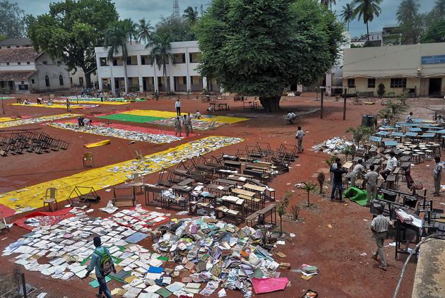 Students of a school, which was flooded by the Krishna river, dry up books, furniture and other articles, after the flood-water receded from their school campus, in Sangli district of Maharashra. (PTI) Students of a school, which was flooded by the Krishna river, dry up books, furniture and other articles, after the flood-water receded from their school campus, in Sangli district of Maharashra. (PTI)