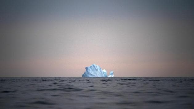 A large iceberg floats away as the sun sets near Kulusuk. New York University air and ocean scientist David Holland, who is tracking what’s happening in Greenland from both above and below, calls it “the end of the planet.” He and other scientists are hard at work, trying to understand the alarmingly rapid melting of the ice. (Felipe Dana / AP) A large iceberg floats away as the sun sets near Kulusuk. New York University air and ocean scientist David Holland, who is tracking what’s happening in Greenland from both above and below, calls it “the end of the planet.” He and other scientists are hard at work, trying to understand the alarmingly rapid melting of the ice. (Felipe Dana / AP)