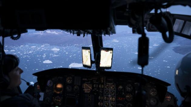 A helicopter flies over hundreds of icebergs floating near the Helheim glacier, in Greenland. The glacier, which is on the southeastern edge of the giant frozen island, is one of Greenland’s fastest-retreating glaciers. It has shrunk about 10 kilometre since scientists came here in 2005. (Felipe Dana / AP) A helicopter flies over hundreds of icebergs floating near the Helheim glacier, in Greenland. The glacier, which is on the southeastern edge of the giant frozen island, is one of Greenland’s fastest-retreating glaciers. It has shrunk about 10 kilometre since scientists came here in 2005. (Felipe Dana / AP)