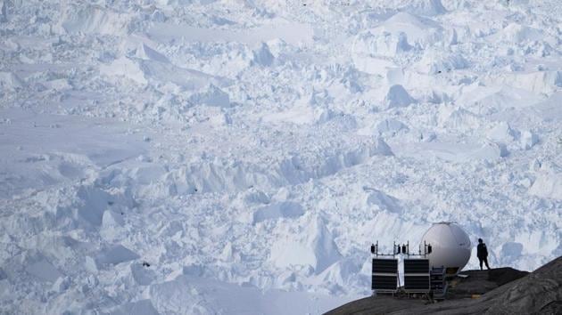 A woman stands next to an antenna at an NYU base camp at the Helheim glacier in Greenland. In just the five days from July 31 to August 3, more than 58 billion tons (53 billion metric tons) melted from the surface. That’s over 40 billion tons more than the average for this time of year. (Felipe Dana / AP) A woman stands next to an antenna at an NYU base camp at the Helheim glacier in Greenland. In just the five days from July 31 to August 3, more than 58 billion tons (53 billion metric tons) melted from the surface. That’s over 40 billion tons more than the average for this time of year. (Felipe Dana / AP)