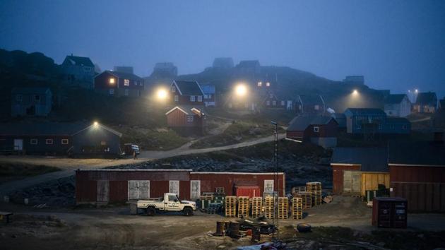 An early morning fog shrouds homes in Kulusuk. Mugu Utuaq, a resident of the town – that is a 40-minute helicopter ride from the Helheim glacier -- says the winter that used to last as much as 10 months when he was a boy can now be as short as five months. That matters to him because as the fourth-ranked dogsledder in Greenland, he has 23 dogs and needs to race them. (Felipe Dana / AP) An early morning fog shrouds homes in Kulusuk. Mugu Utuaq, a resident of the town – that is a 40-minute helicopter ride from the Helheim glacier -- says the winter that used to last as much as 10 months when he was a boy can now be as short as five months. That matters to him because as the fourth-ranked dogsledder in Greenland, he has 23 dogs and needs to race them. (Felipe Dana / AP)