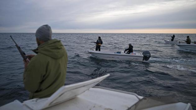 Mugu Utuaq, left, reloads his rifle as he rides with other boats hunting whales near Kulusuk. The dogs can’t race in the summer, but they still have to eat. So Utuaq and friends go whale hunting with rifles in small boats. “People are getting rid of their dogs because there’s no season,” said Yewlin, another resident. He used to run a sled dog team for tourists at a hotel in neighbouring Tasiilaq, but they no longer can do that. (Felipe Dana / AP) Mugu Utuaq, left, reloads his rifle as he rides with other boats hunting whales near Kulusuk. The dogs can’t race in the summer, but they still have to eat. So Utuaq and friends go whale hunting with rifles in small boats. “People are getting rid of their dogs because there’s no season,” said Yewlin, another resident. He used to run a sled dog team for tourists at a hotel in neighbouring Tasiilaq, but they no longer can do that. (Felipe Dana / AP)