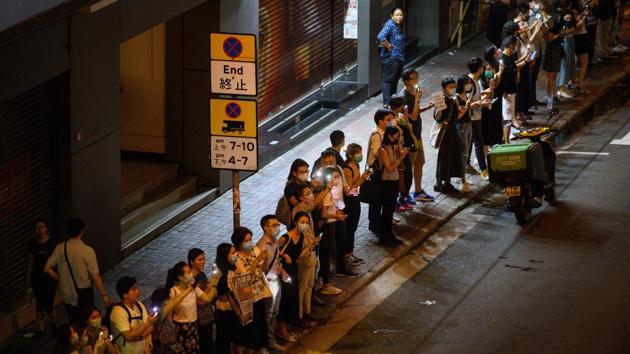 People use their phone torches as they form a human chain in Hong Kong. The protest in Hong Kong coincided with the 30th anniversary of the Baltic Way demonstration in 1989, which saw about 2 million people form a human chain that spanned over 600 kilometres across Estonia, Latvia and Lithuania in protest against Soviet occupation. (Anthony Wallace / AFP) People use their phone torches as they form a human chain in Hong Kong. The protest in Hong Kong coincided with the 30th anniversary of the Baltic Way demonstration in 1989, which saw about 2 million people form a human chain that spanned over 600 kilometres across Estonia, Latvia and Lithuania in protest against Soviet occupation. (Anthony Wallace / AFP)