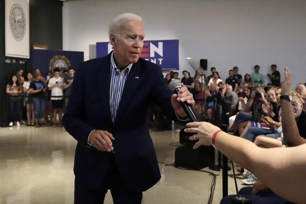 Democratic presidential candidate former Vice President Joe Biden hands a microphone to a questioner during a campaign event at Dartmouth College.(AP)