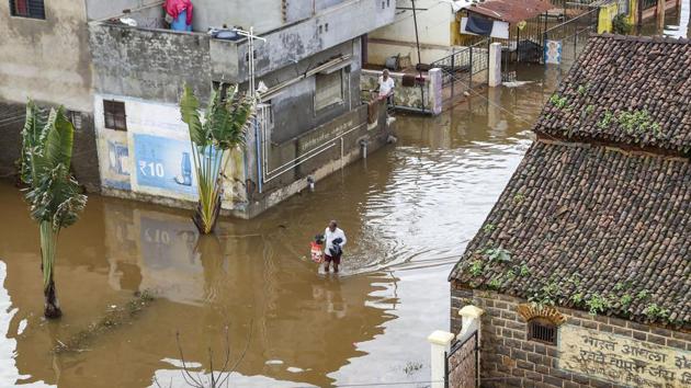 Kolhapur: A man walks through a flooded area following incessant rainfall in Kolhapur district (PTI file) Kolhapur: A man walks through a flooded area following incessant rainfall in Kolhapur district (PTI file)
