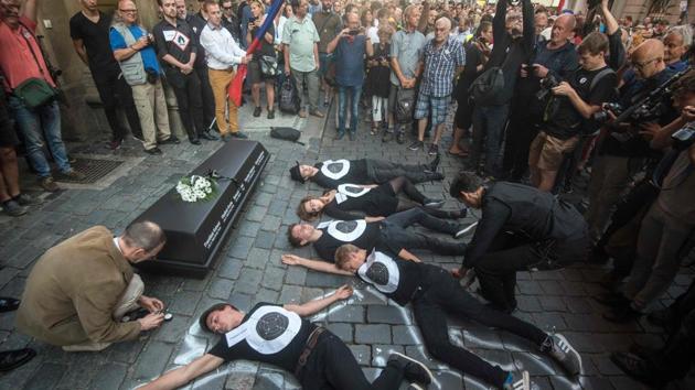 People lay on the pavement in front of the Czech Communist party headquarter as a symbol of the people who died 50 years ago during demonstration marking the first anniversary of the Soviet-led occupation, in Prague, Czech Republic. (Michal Cizek / AFP) People lay on the pavement in front of the Czech Communist party headquarter as a symbol of the people who died 50 years ago during demonstration marking the first anniversary of the Soviet-led occupation, in Prague, Czech Republic. (Michal Cizek / AFP)