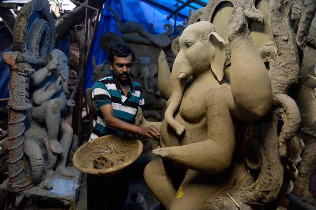 An artist works on a sculpture of Hindu God Lord Ganesh made with ecological materials to reduce pollution during the immersion for the Ganesh Chaturthi festival, at a workshop in Hyderabad, Telangana. (Noah Seelam / AFP) An artist works on a sculpture of Hindu God Lord Ganesh made with ecological materials to reduce pollution during the immersion for the Ganesh Chaturthi festival, at a workshop in Hyderabad, Telangana. (Noah Seelam / AFP)