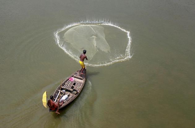 Balurghat: A fisherman casts his net in the Atrai river at Balurghat in South Dinajpur district of West Bengal. (PTI) Balurghat: A fisherman casts his net in the Atrai river at Balurghat in South Dinajpur district of West Bengal. (PTI)