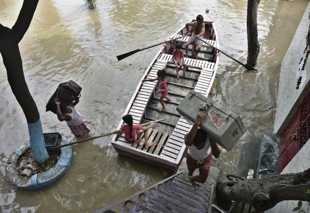Residents of Yamuna Bazar carry their belongings through an alley flooded with the Yamuna water, in New Delhi. Several low-lying areas along the Yamuna were today flooded as the water level in the river was flowing two metre above the danger mark and inching towards touching the highest level. (Raj K Raj / HT Photo) Residents of Yamuna Bazar carry their belongings through an alley flooded with the Yamuna water, in New Delhi. Several low-lying areas along the Yamuna were today flooded as the water level in the river was flowing two metre above the danger mark and inching towards touching the highest level. (Raj K Raj / HT Photo)