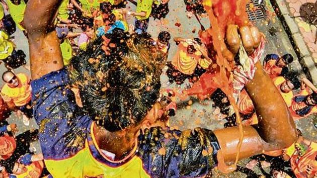 A devotee breaks a dahi-handi (curd-pot) suspended in the air atop a human pyramid during celebrations for the Janmashtami festival, which marks the birth of Hindu God Lord Krishna, at Dadar in Mumbai (Kunal Patil/Hindustan Times) A devotee breaks a dahi-handi (curd-pot) suspended in the air atop a human pyramid during celebrations for the Janmashtami festival, which marks the birth of Hindu God Lord Krishna, at Dadar in Mumbai (Kunal Patil/Hindustan Times)
