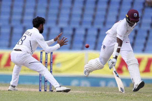 West Indies' Miguel Cummins makes it safely to his ground before India's Ravindra Jadeja. (AP) West Indies' Miguel Cummins makes it safely to his ground before India's Ravindra Jadeja. (AP)