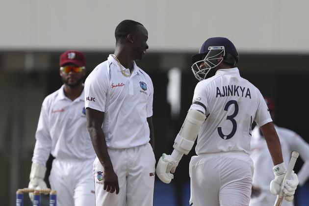 West Indies' bowler Kemar Roach, left, and India's Ajinkya Rahane talk during day three. (AP) West Indies' bowler Kemar Roach, left, and India's Ajinkya Rahane talk during day three. (AP)