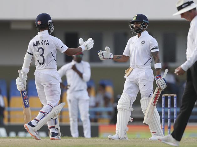 India's captain Virat Kohli, right, is greeted by teammate Ajinkya Rahane after scoring a half century. (AP) India's captain Virat Kohli, right, is greeted by teammate Ajinkya Rahane after scoring a half century. (AP)
