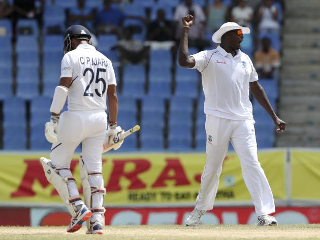 West Indies' captain Jason Holder celebrates the dismissal of India's Cheteshwar Pujara. (AP) West Indies' captain Jason Holder celebrates the dismissal of India's Cheteshwar Pujara. (AP)