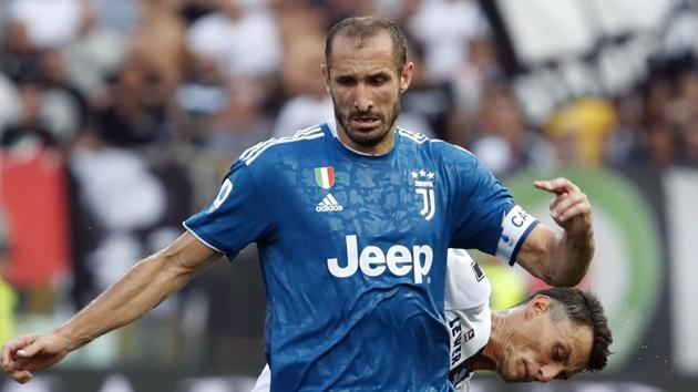 Juventus' Giorgio Chiellini, front, duels for the ball with Parma's Roberto Inglese.(AP)