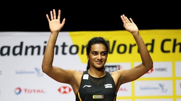 Sindhu celebrates on the podium after winning the women's singles final.(REUTERS)