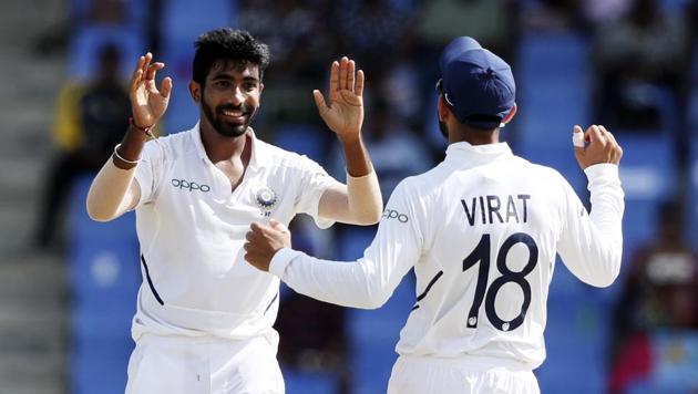 India's Jasprit Bumrah celebrates with team captain Virat Kohli in the first Test.(AP)