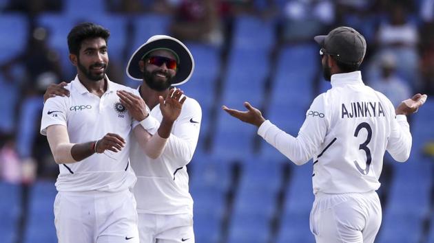 India's Jasprit Bumrah is congratulated by teammates after taking the wicket of West Indies' captain Jason Holder(AP)