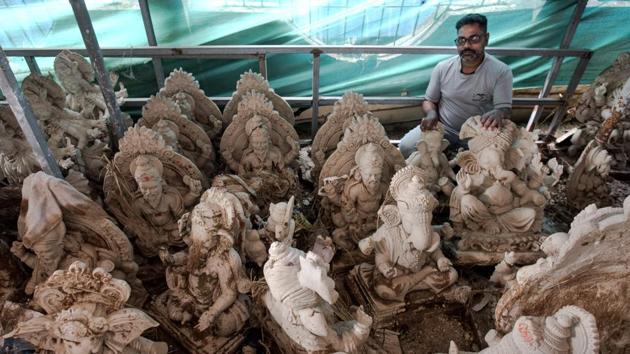 Ravindra Rasal, 45, stands among a range of idols, most of Ganesha at his workshop in Pen. The month leading up to Ganesh Chaturthi in September is a busy one for idol makers like Rasal in Pen, which comes alive as orders pour in from far and wide. This year, the delayed yet heavy monsoon washed away much of artisans’ early efforts. (Satish Bate / HT Photo) Ravindra Rasal, 45, stands among a range of idols, most of Ganesha at his workshop in Pen. The month leading up to Ganesh Chaturthi in September is a busy one for idol makers like Rasal in Pen, which comes alive as orders pour in from far and wide. This year, the delayed yet heavy monsoon washed away much of artisans’ early efforts. (Satish Bate / HT Photo)