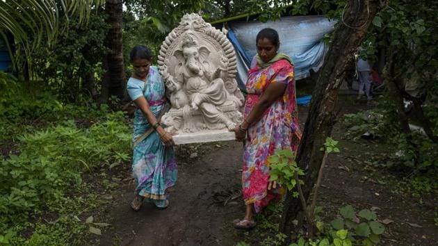 Women salvage an idol at Hamrapur village in Pen. Pen’s association with Ganesha idols stretches back to the 1980s, when then town stepped up to cater to a rising demand for idols of the elephant-headed god, as the Ganesha Festival saw a surge in popularity across India and among the Maharashtrian diaspora. (Satish Bate / HT Photo) Women salvage an idol at Hamrapur village in Pen. Pen’s association with Ganesha idols stretches back to the 1980s, when then town stepped up to cater to a rising demand for idols of the elephant-headed god, as the Ganesha Festival saw a surge in popularity across India and among the Maharashtrian diaspora. (Satish Bate / HT Photo)
