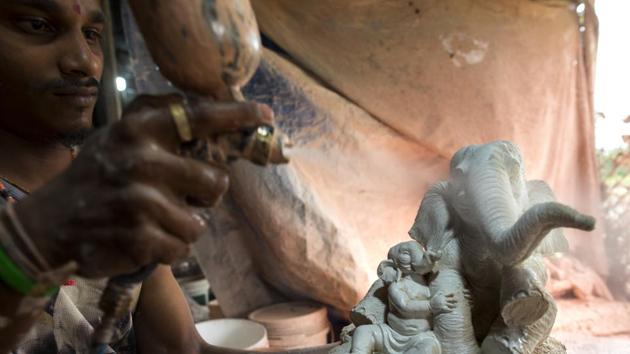 The first coats of paint are sprayed on to a smaller idol. While the boom of Pen’s idol trade was in part due to the introduction of Plaster of Paris idols that were quicker to dry –speeding up production –curbs on its use and that of chemical dyes due to their environmental impact have renewed interest among artisans and buyers for natural pigments and base materials. (Satish Bate / HT Photo) The first coats of paint are sprayed on to a smaller idol. While the boom of Pen’s idol trade was in part due to the introduction of Plaster of Paris idols that were quicker to dry –speeding up production –curbs on its use and that of chemical dyes due to their environmental impact have renewed interest among artisans and buyers for natural pigments and base materials. (Satish Bate / HT Photo)